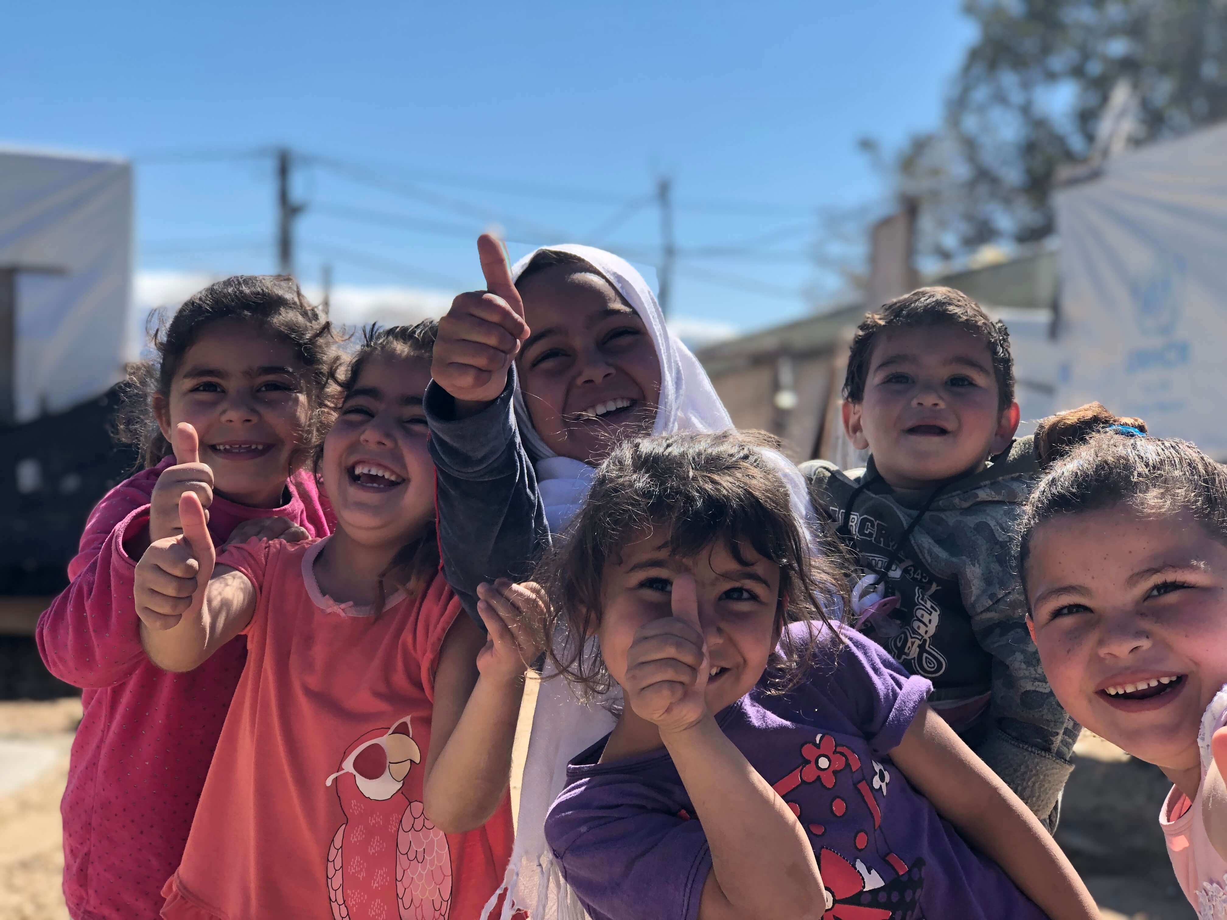 Syrian kids laugh and play at home in their informal settlement in Mhammara, northern Lebanon where 29 families live together with support from UNHCR. 