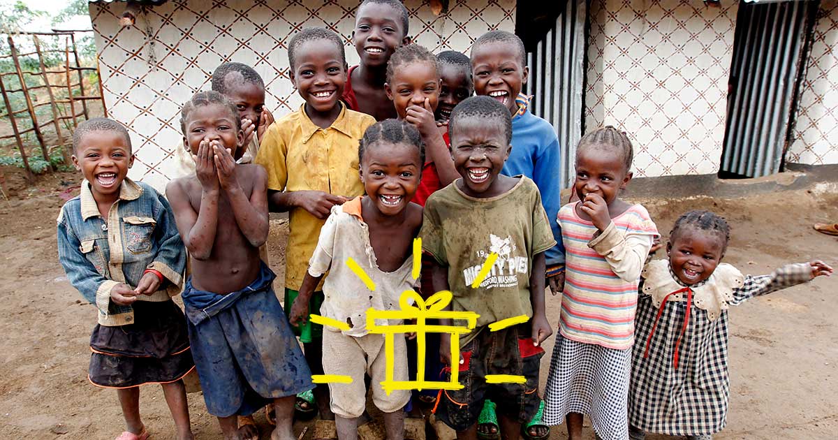 A group of smiling refugee children with a gift emoji superimposed over the image