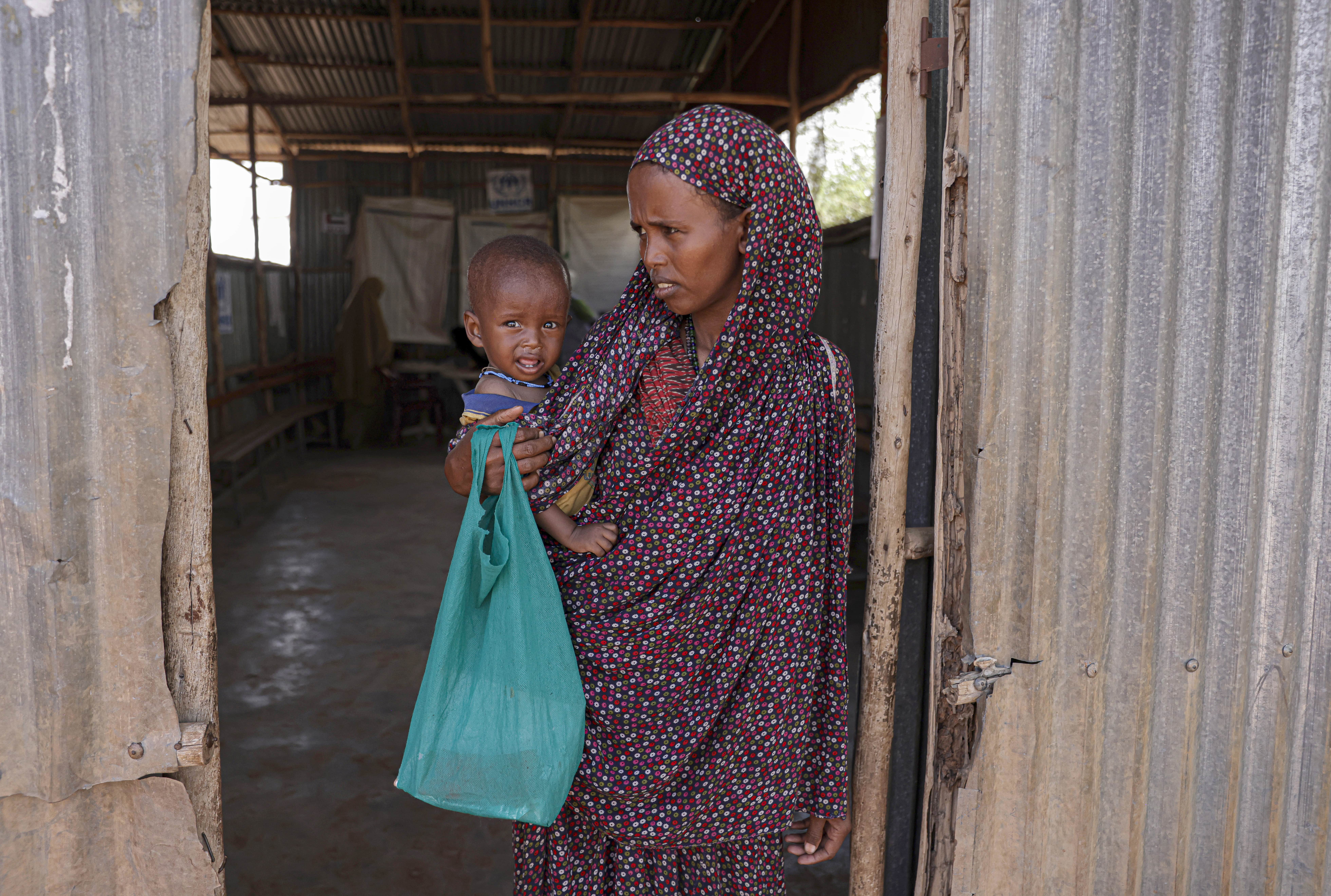 Samira Abdi, 28 waits to receive food and treatment for her malnourished child at the Melkadida UNHCR supported food distribution centre in Melkadida