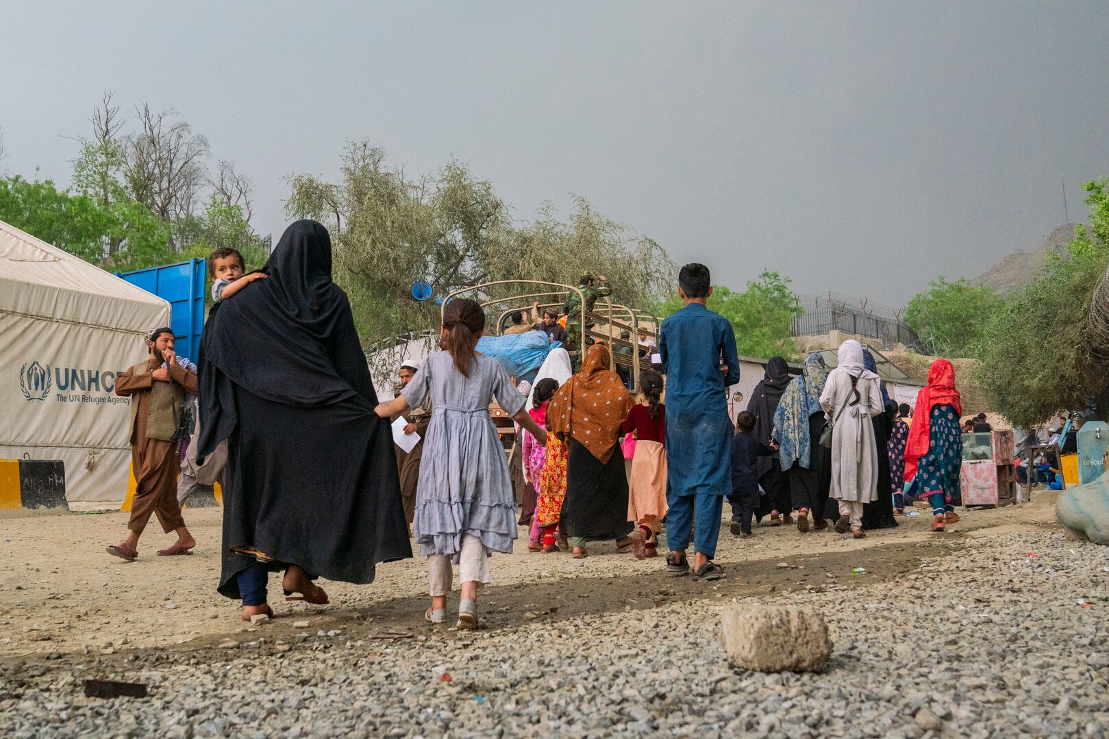 Families at the Torkham border, newly arrived from Pakistan, prepare for the next step of their journey.