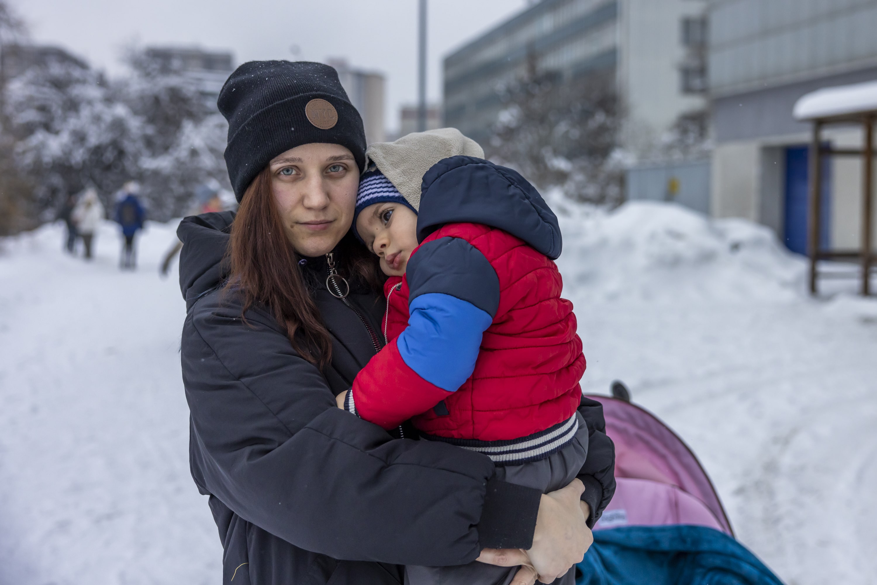 Woman holds child in the snow. Kateryna fled her hometown of Kryvyi Rih in southern Ukraine on 6 March. 