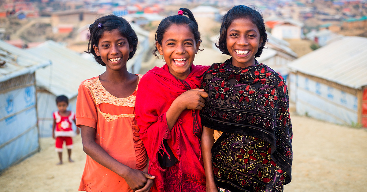 Three young girls, smiling at camera. © UNHCR/Roger Arnold