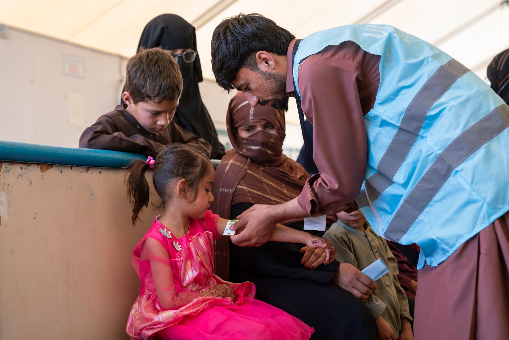 Ayesha, 5, recently returned from Pakistan with his family. At the UNHCR Encashment Centre, he receives a health check-up and vaccination as part of the support provided to help families settle back into life in Afghanistan safely and healthily