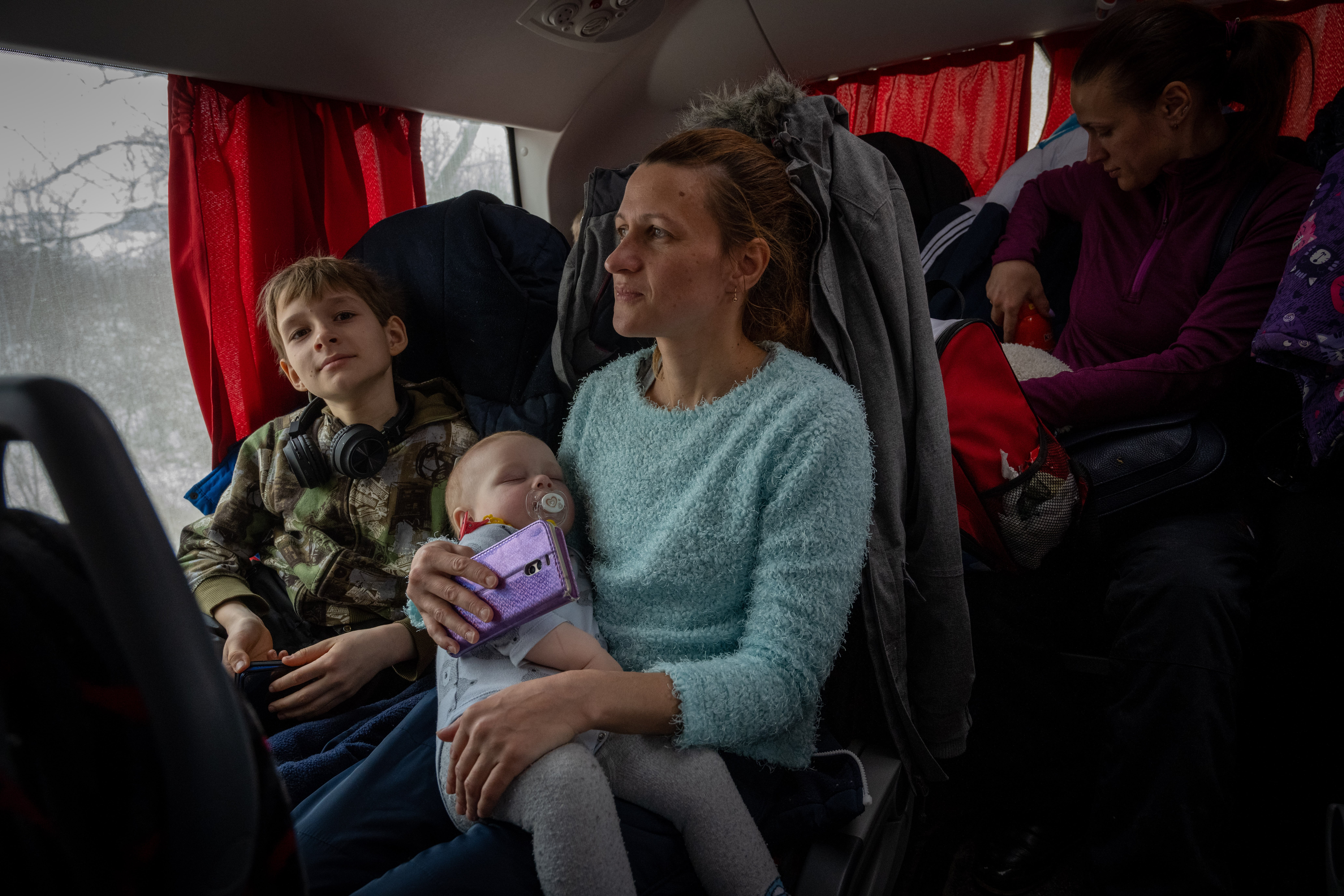 Natalia, 35, from Mykolaiv in southern Ukraine travels with her two children on a bus from the Moldovan border town of Palanca to Hu?i in Romania.