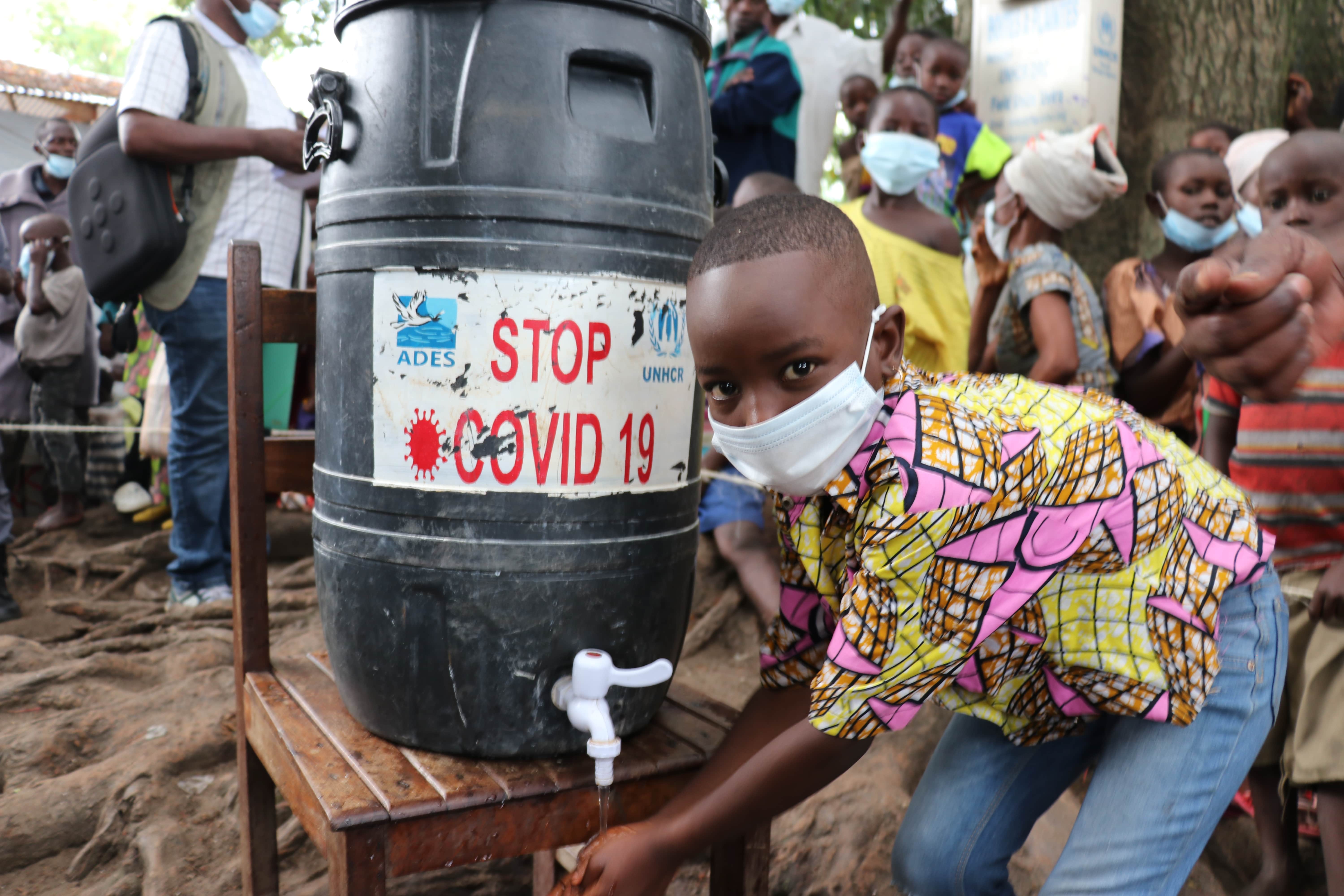 Young Burundian refugee washes hands at Kavimvira transit centre in South Kivu, Democratic Republic of Congo.